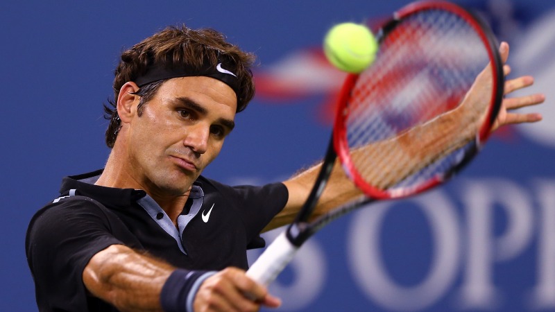 Roger Federer of Switzerland returns a shot against Marinko Matosevic of Australia