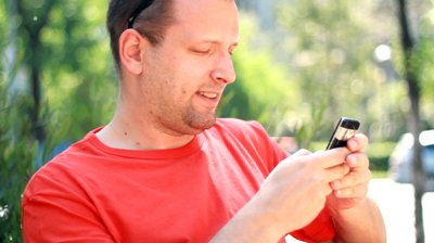 stock-footage-happy-man-sending-sms-texting-in-the-city