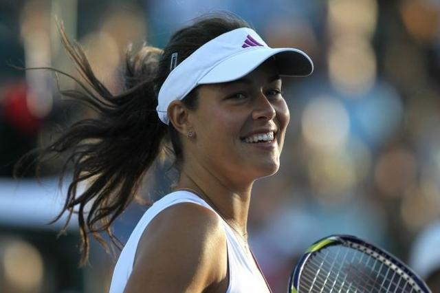 Ana Ivanovic in a white Adidas tennis dress smiling